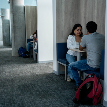 Meeting space with students engaged in conversation.