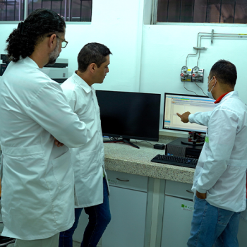 Faculty Members Discussing While Looking at a Computer