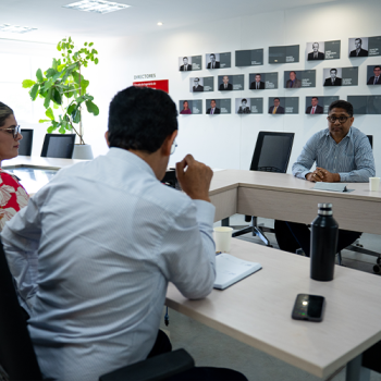 Faculty Members Discussing in a Meeting Room
