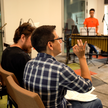 Instructor with Students in a Rehearsal Room